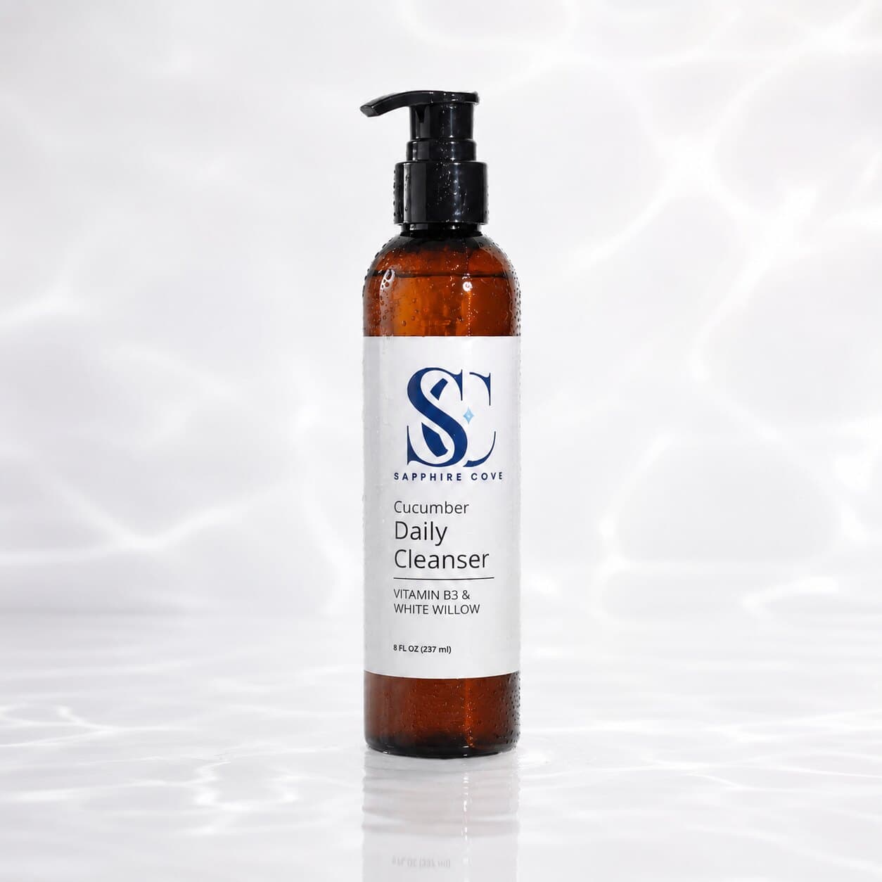 Sapphire Cove Cucumber Daily Cleanser in an 8 oz amber pump bottle, made with cucumber, Vitamin B3, and white willow.