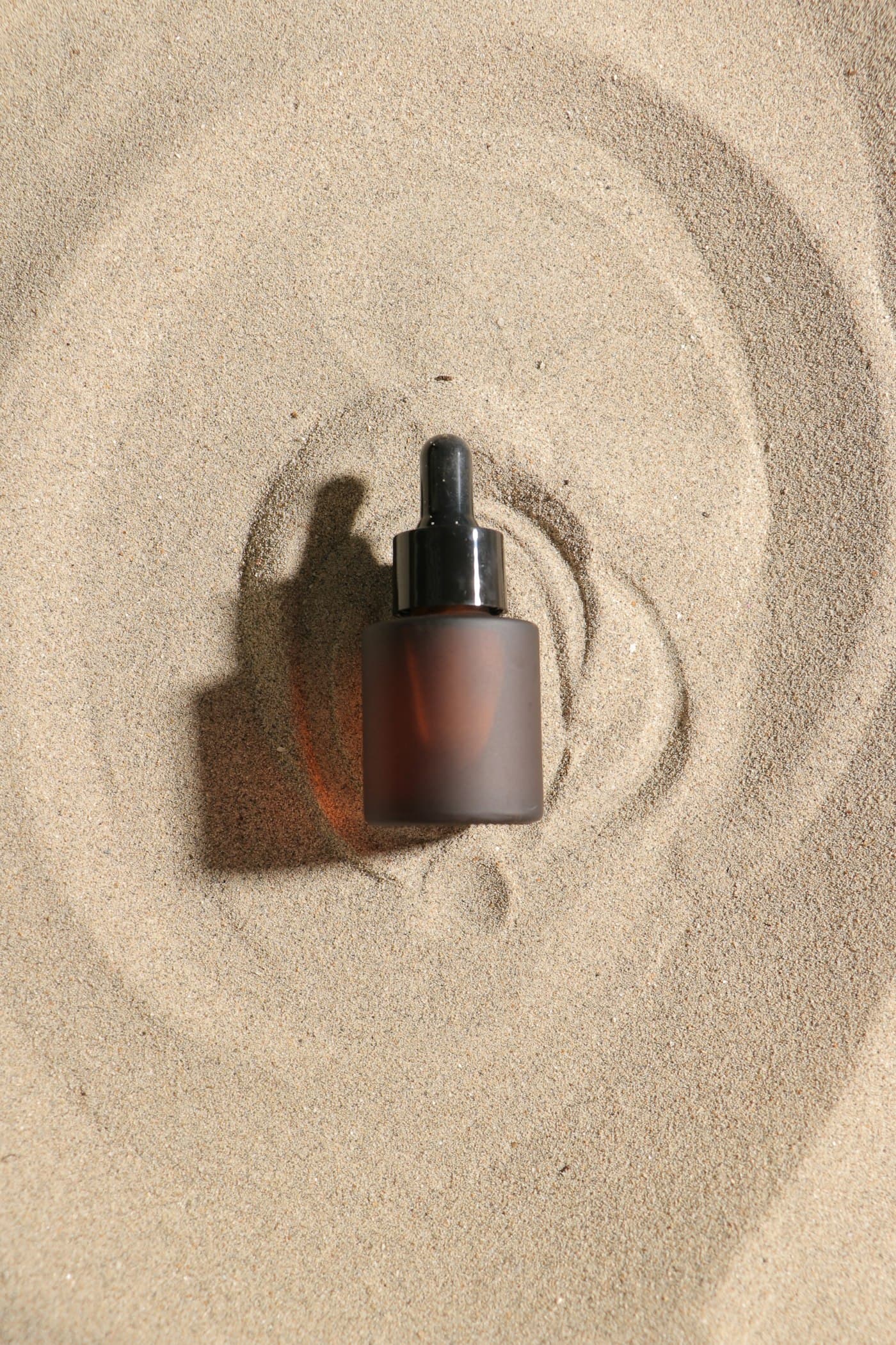 Minimal serum bottle on a warm neutral surface
